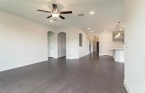 a view of an empty room with a kitchen
