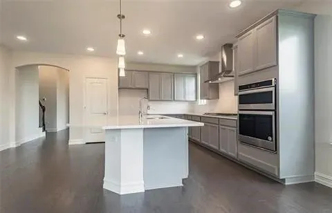 a kitchen with stainless steel appliances granite countertop a refrigerator and a sink