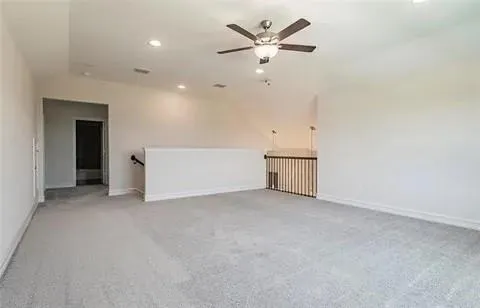 an empty room with closet and a ceiling fan