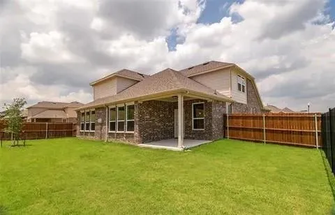 a view of a house with a yard and sitting area