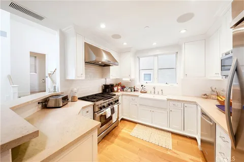 a kitchen with a stove a sink and a refrigerator