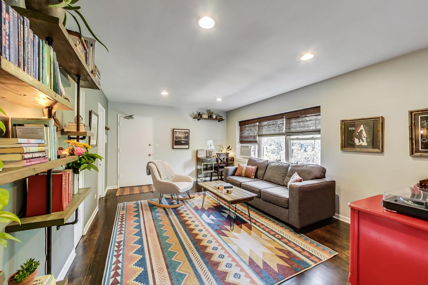 205 Custer Avenue, Unit 3 Evanston, IL 60202 - Photo 4 of 12 a living room with furniture fireplace and wooden floor