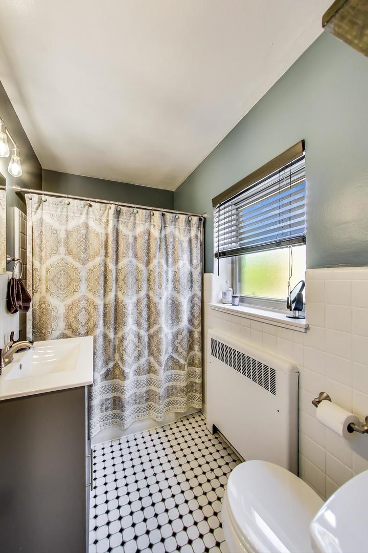 205 Custer Avenue, Unit 3 Evanston, IL 60202 - Photo 10 of 12 a bathroom with a sink toilet and shower