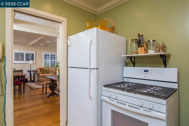 a kitchen with a stove a refrigerator and a dining table