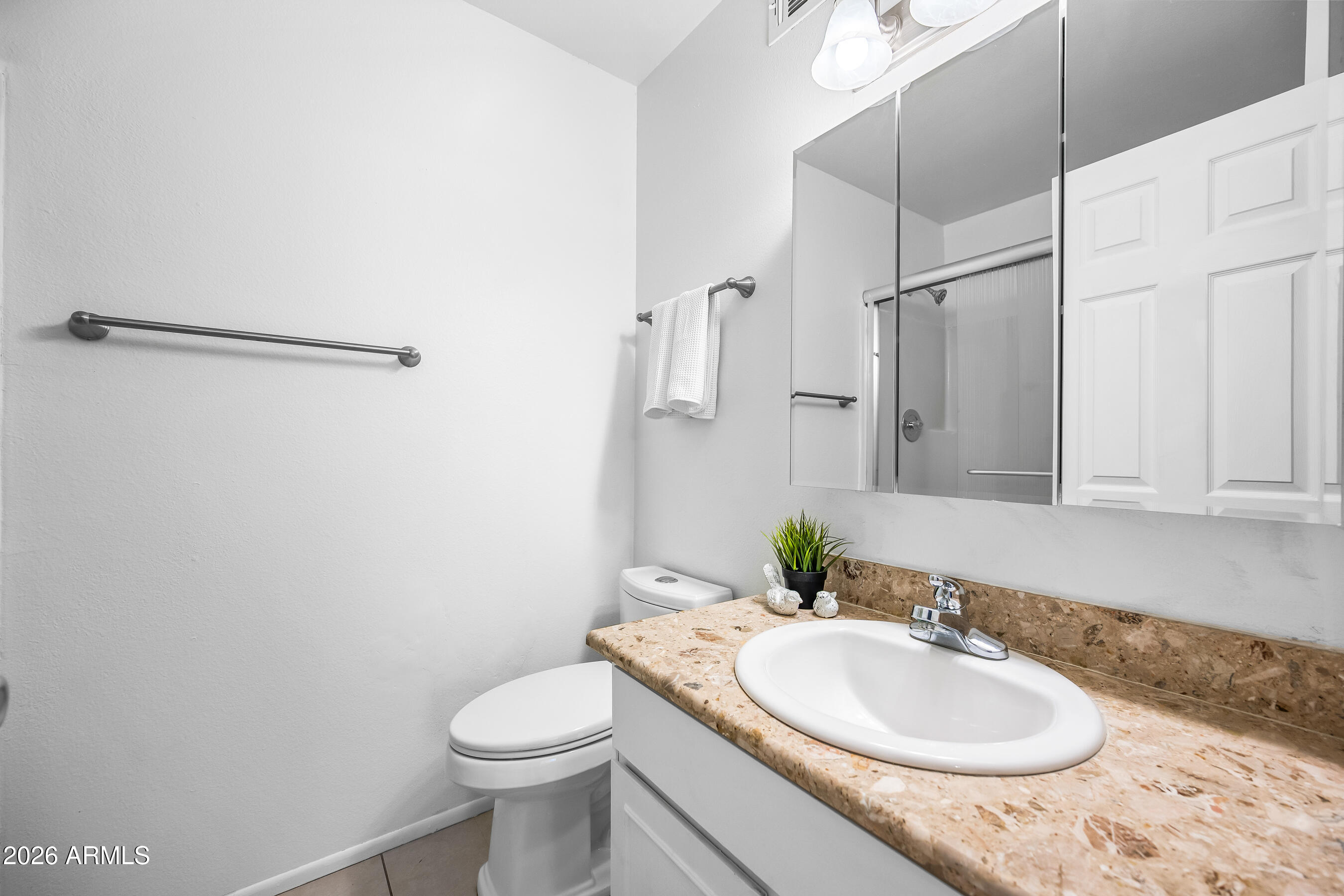 4815 South Birch Street Tempe, AZ 85282 - Photo 16 of 25 a bathroom with a granite countertop sink toilet and a mirror