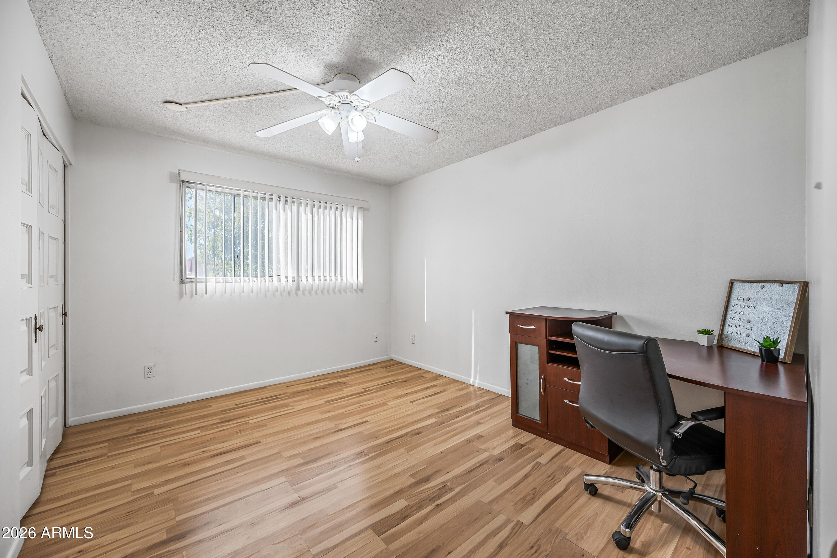 4815 South Birch Street Tempe, AZ 85282 - Photo 20 of 25 a workspace with wooden floor windows chair and a ceiling fan