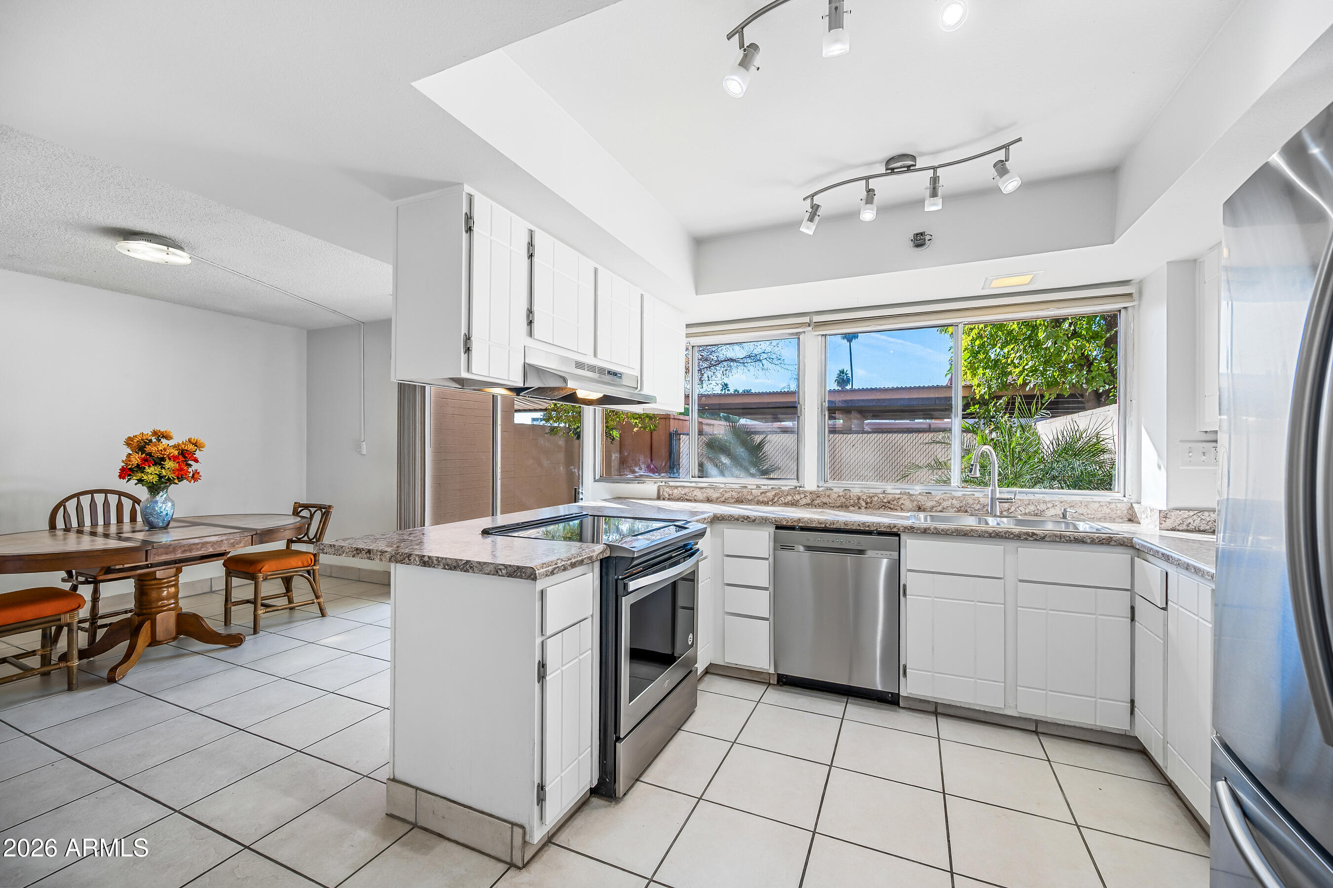 4815 South Birch Street Tempe, AZ 85282 - Photo 4 of 25 a kitchen with a sink and chairs