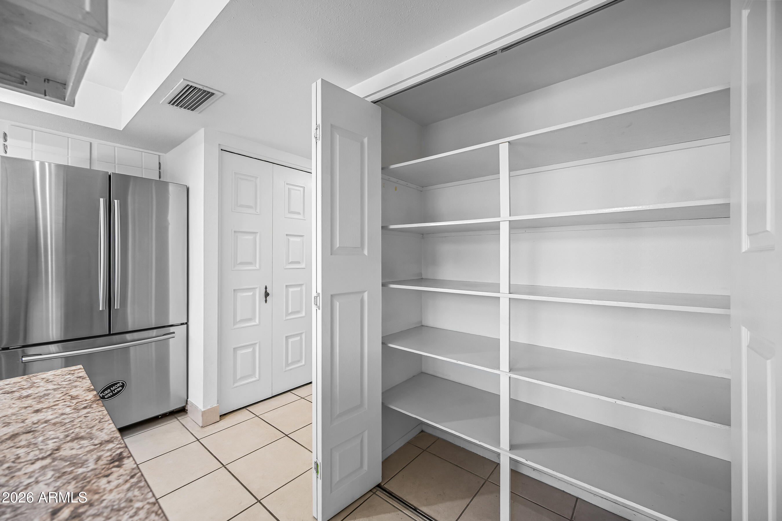 4815 South Birch Street Tempe, AZ 85282 - Photo 10 of 25 a view of walk in closet with empty racks