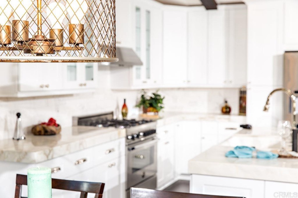 768 Devonshire Drive Encinitas, CA 92024 - Photo 12 of 30 a kitchen with stainless steel appliances a sink and cabinets