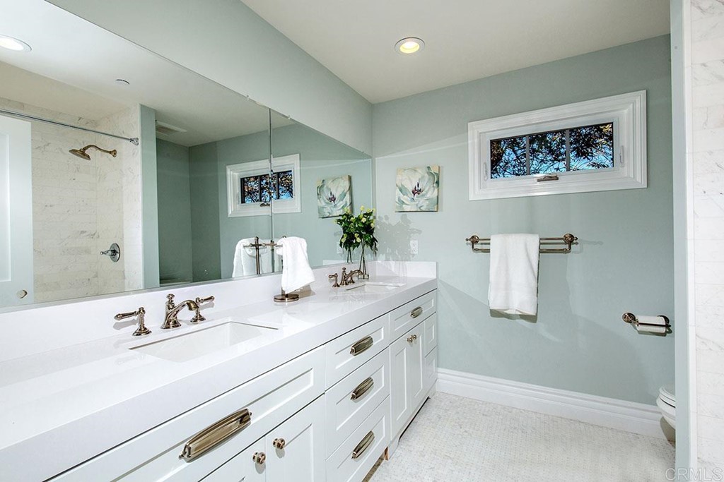 768 Devonshire Drive Encinitas, CA 92024 - Photo 21 of 30 a bathroom with a double vanity sink and a mirror