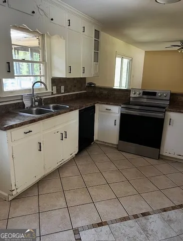 a kitchen with granite countertop a sink and a stove
