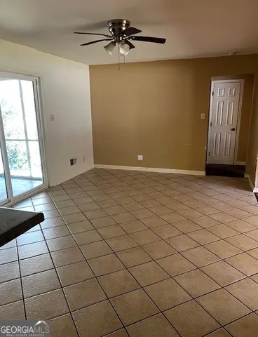 a view of an empty room and a window