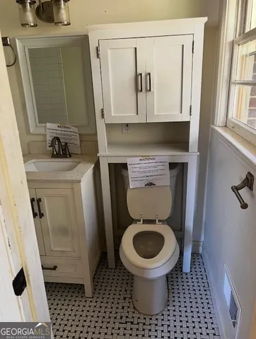 a bathroom with a toilet and a sink