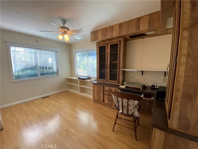 a view of a workspace with furniture and a window