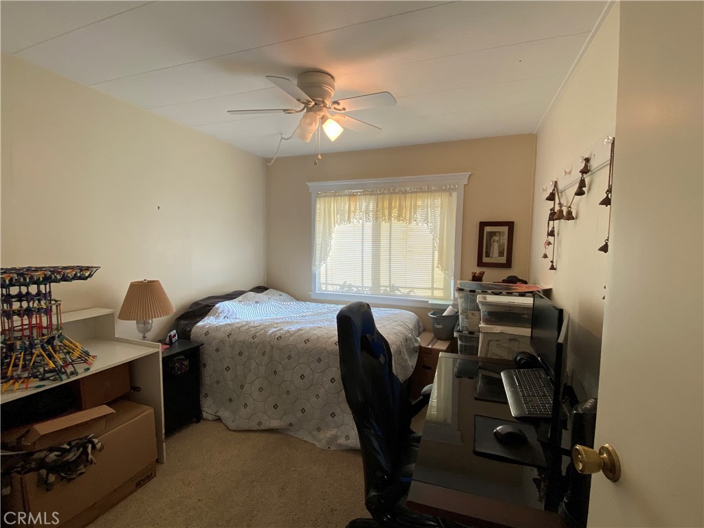 9607 Rosedale Drive Calimesa, CA 92320 - Photo 14 of 27 a bedroom with a bed and a chandelier