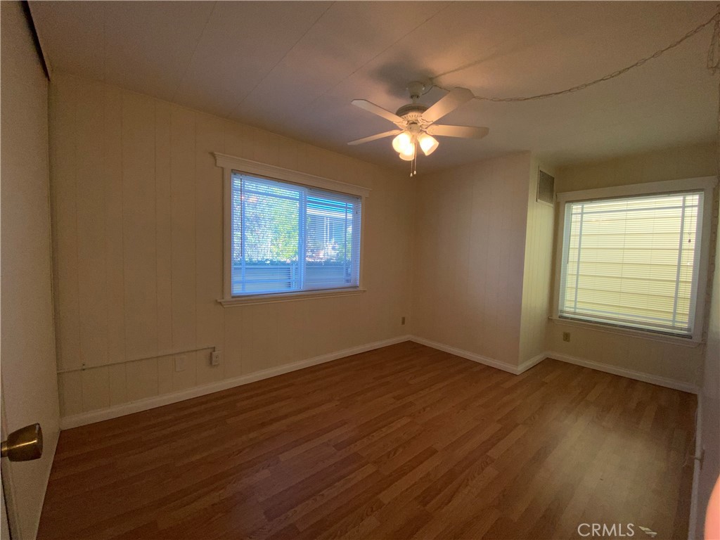 9607 Rosedale Drive Calimesa, CA 92320 - Photo 16 of 27 a view of an empty room with wooden floor and a window