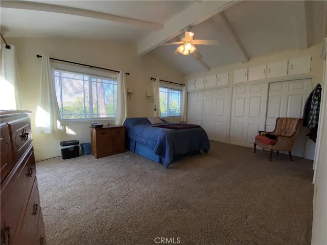 a bed room with a bed and a chair