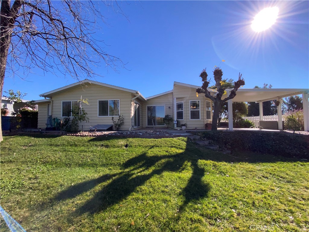 9607 Rosedale Drive Calimesa, CA 92320 - Photo 25 of 27 a front view of a house with a yard table and chairs