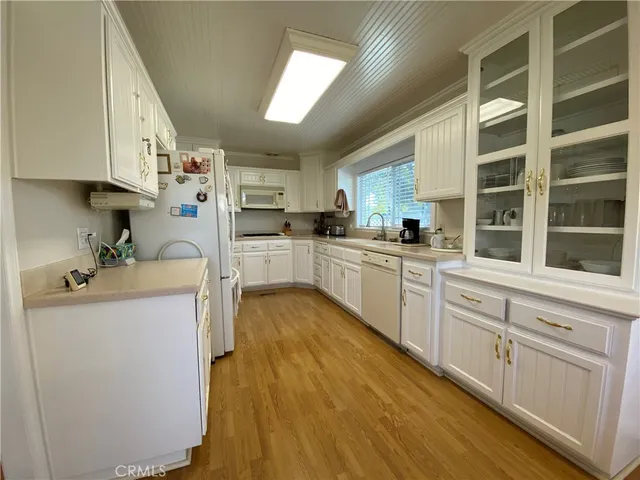 a kitchen with cabinets a sink and appliances