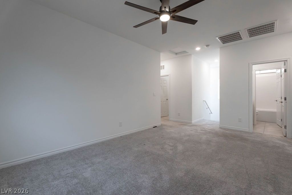 7126 Calvert Cliffs Street North Las Vegas, NV 89084 - Photo 17 of 44 Well-lit and spacious, this room boasts soft carpeting and convenient access to a full bathroom.