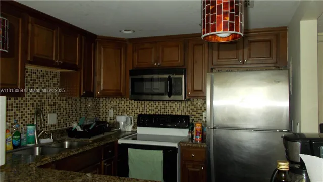 a kitchen with a sink stove and refrigerator