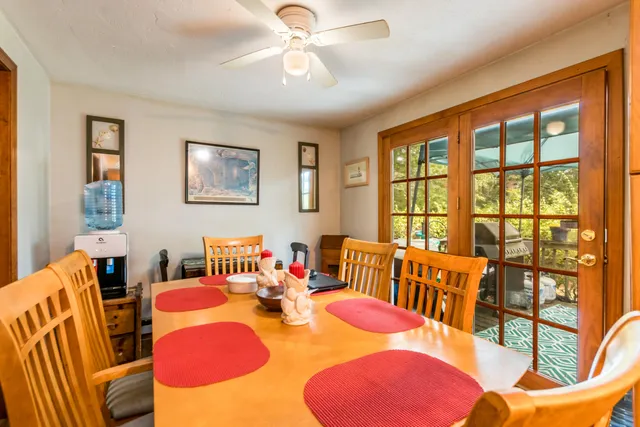 a dining room with furniture and a floor to ceiling window