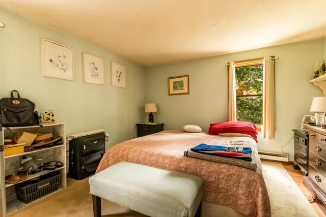 a dining room with furniture a rug and a large window