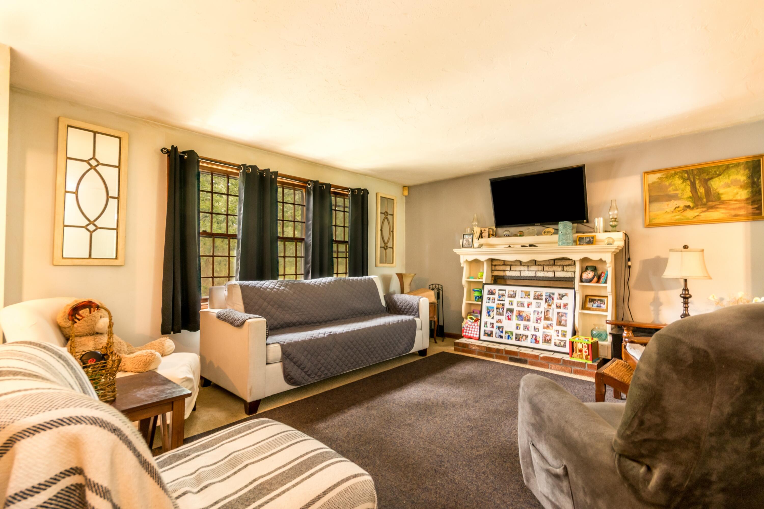 66 Braxton Road East Falmouth, MA 02536 - Photo 6 of 17 a living room with furniture a flat screen tv and a large window