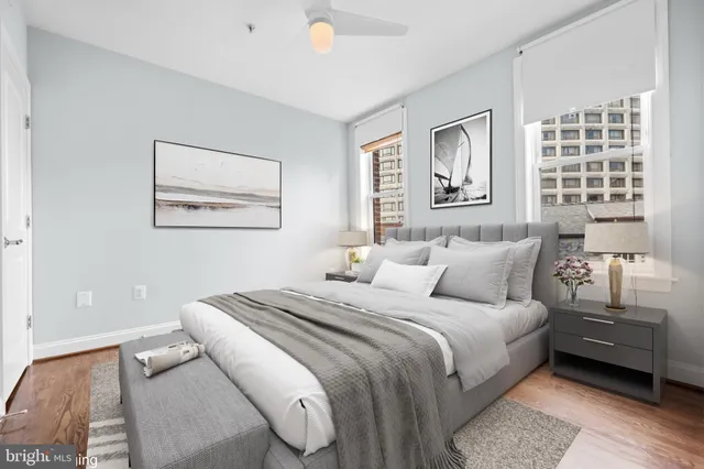 a bedroom with a bed and a painting on the wall