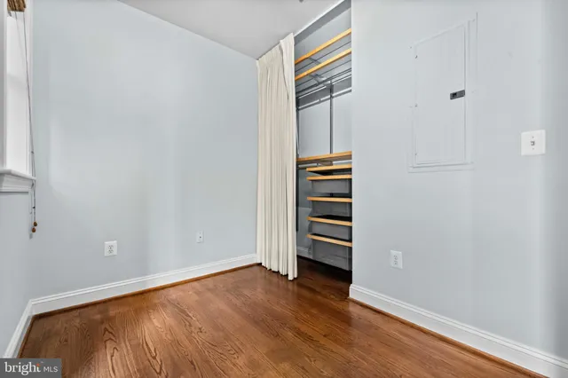 a view of room with stairs and wooden floor