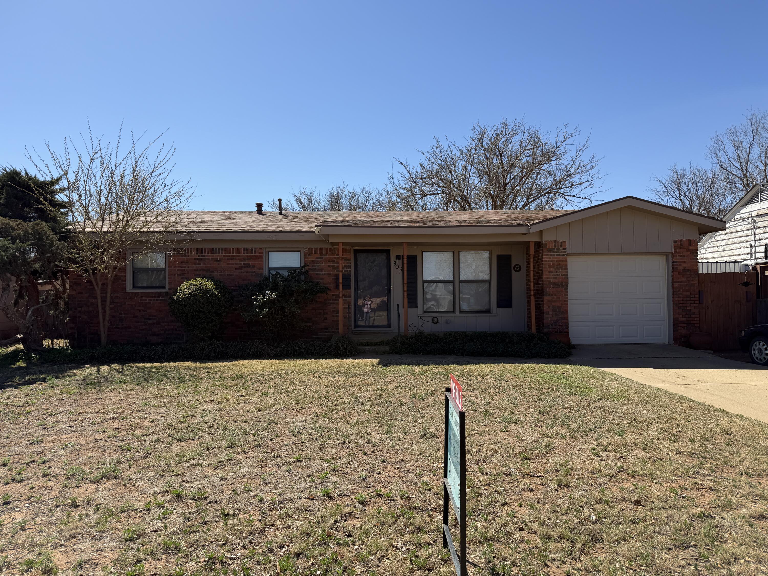 303 North 21st Place Lamesa, TX 79331 - Photo 1 of 35 a front view of a house with a yard
