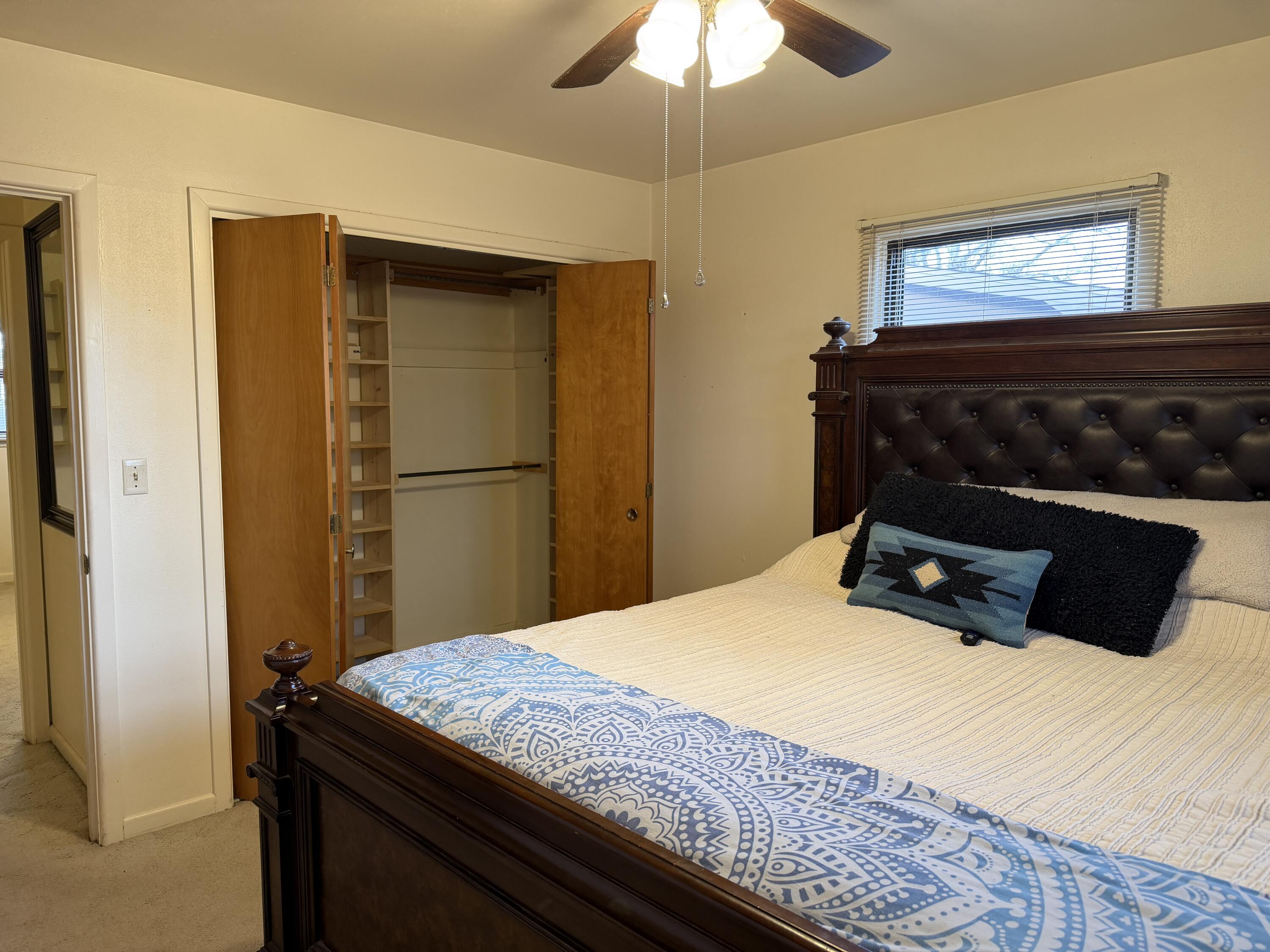 303 North 21st Place Lamesa, TX 79331 - Photo 22 of 35 a bedroom with a bed and a chandelier