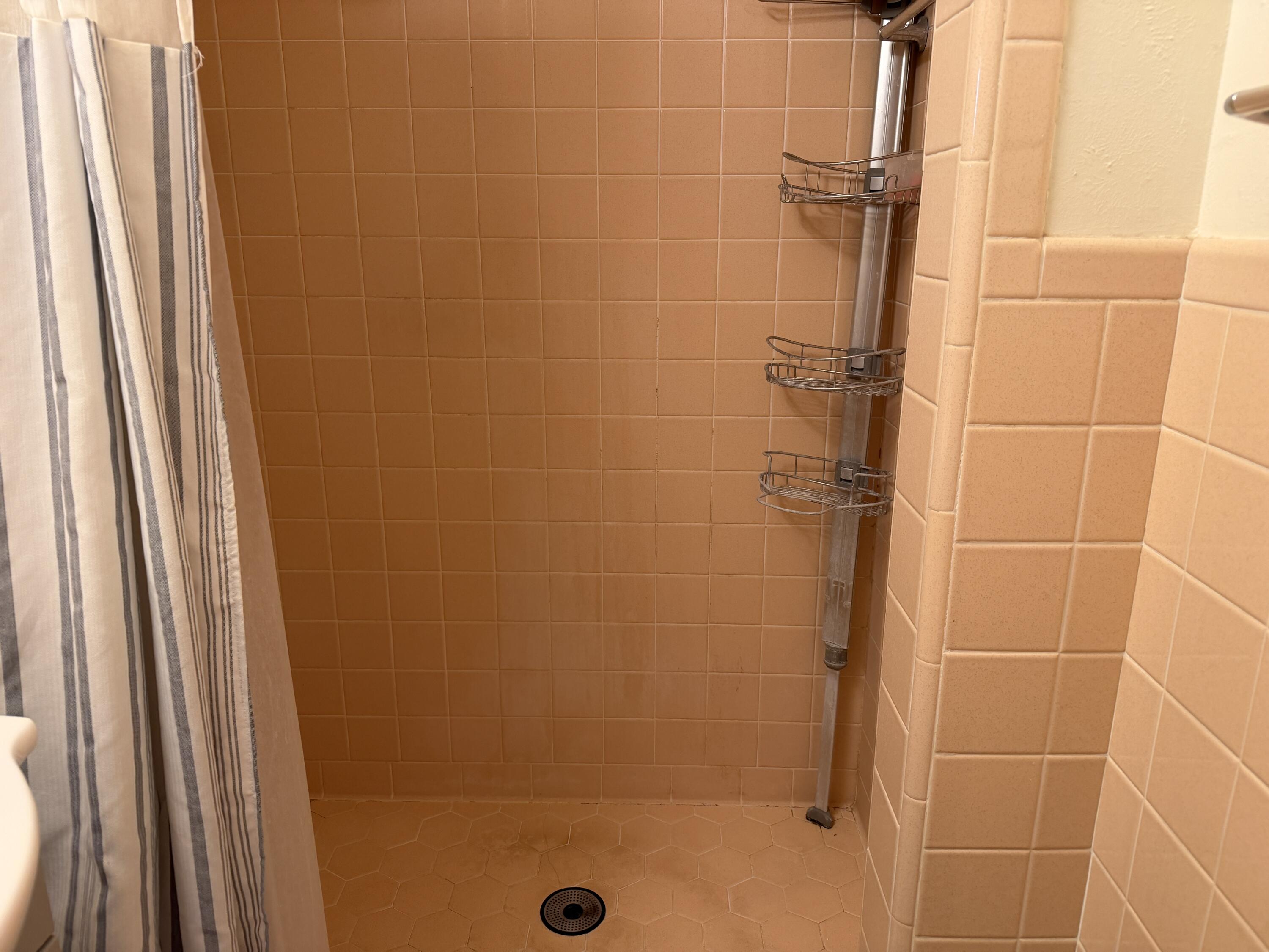 303 North 21st Place Lamesa, TX 79331 - Photo 24 of 35 a bathroom with a glass door shower