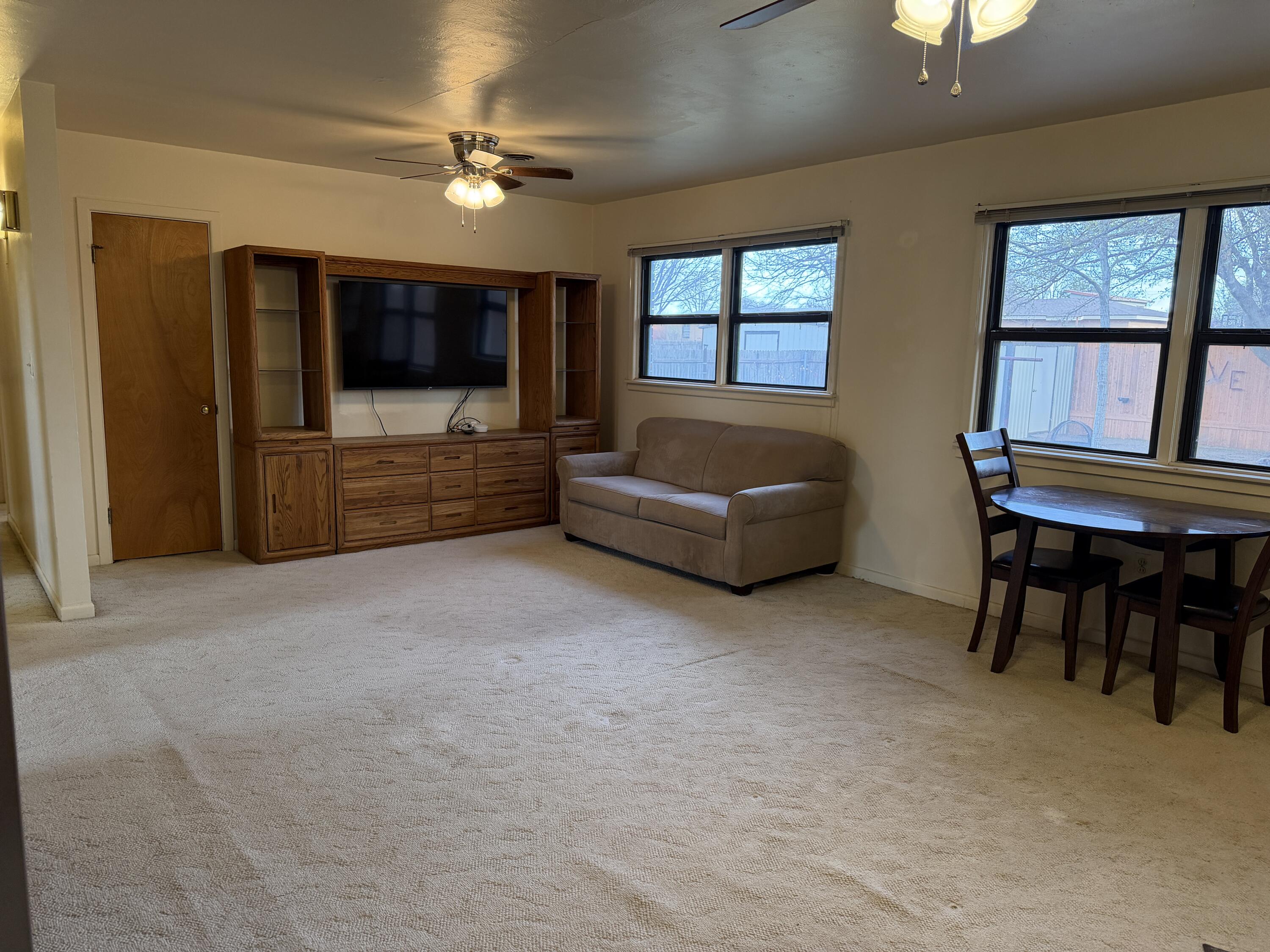303 North 21st Place Lamesa, TX 79331 - Photo 7 of 35 a living room with furniture and a flat screen tv