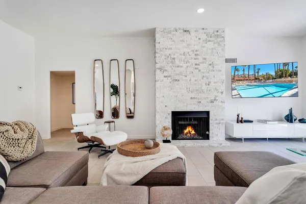 a living room with furniture and fireplace