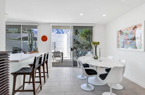 a view of a dining room with furniture and window