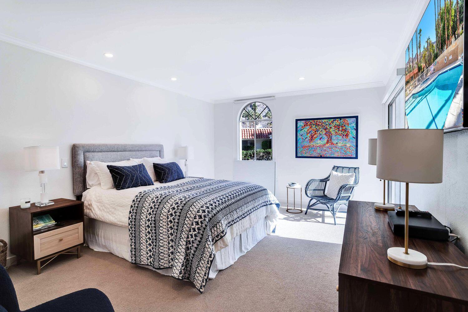 3350 Bogert Trail Palm Springs, CA 92264 - Photo 10 of 21 a spacious bedroom with a bed a couch and a painting on the wall