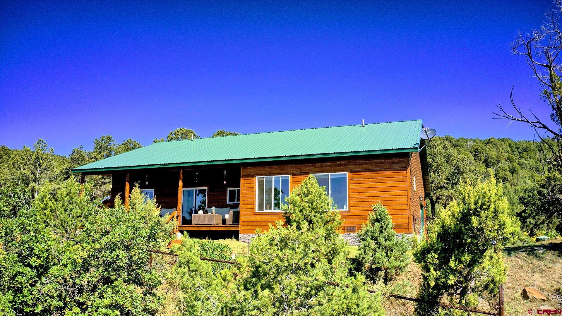 20613 High Park Road Cedaredge, CO 81413 - Photo 11 of 35 a front view of a house with garden