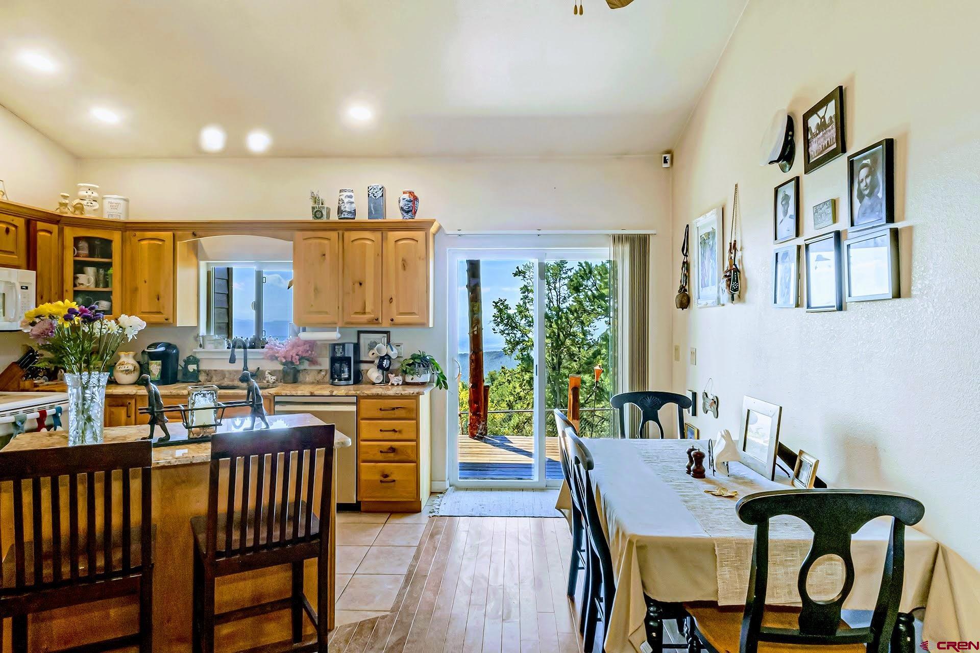 20613 High Park Road Cedaredge, CO 81413 - Photo 16 of 35 a view of a dining room and livingroom with furniture window and wooden floor