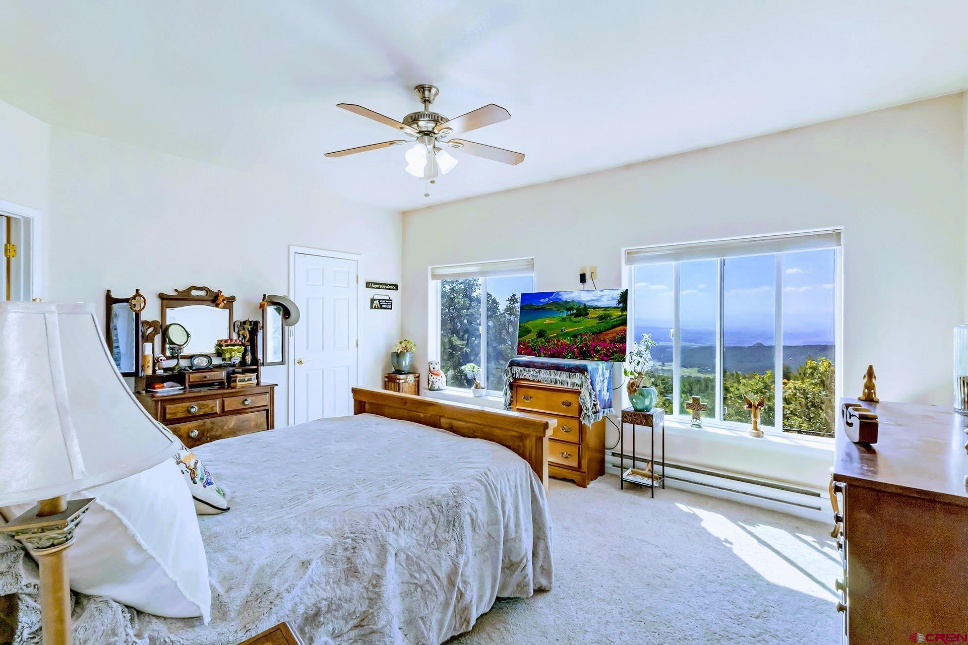 20613 High Park Road Cedaredge, CO 81413 - Photo 19 of 35 a bed room with a bed mirror and a window