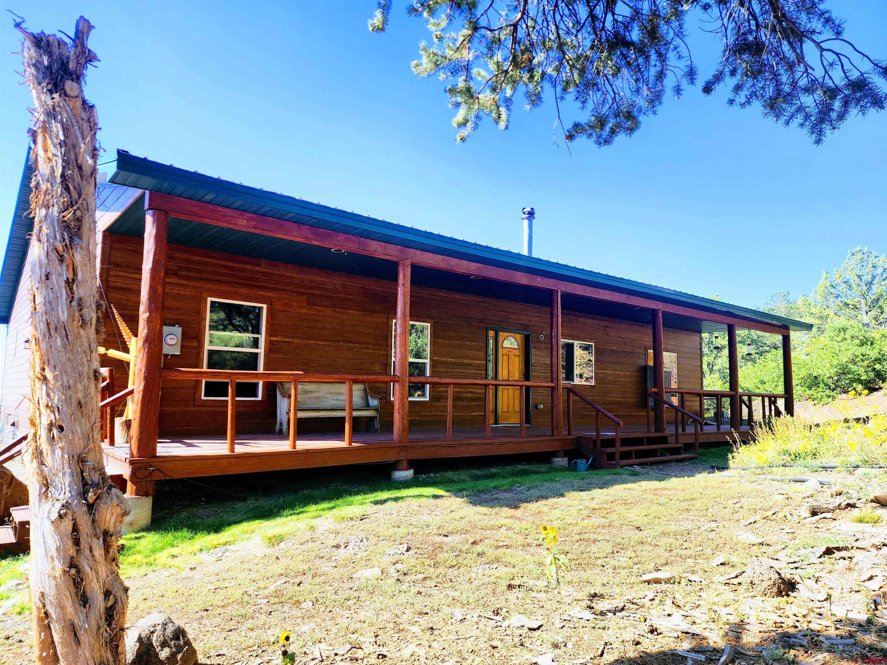 20613 High Park Road Cedaredge, CO 81413 - Photo 2 of 35 a front view of a house with a yard