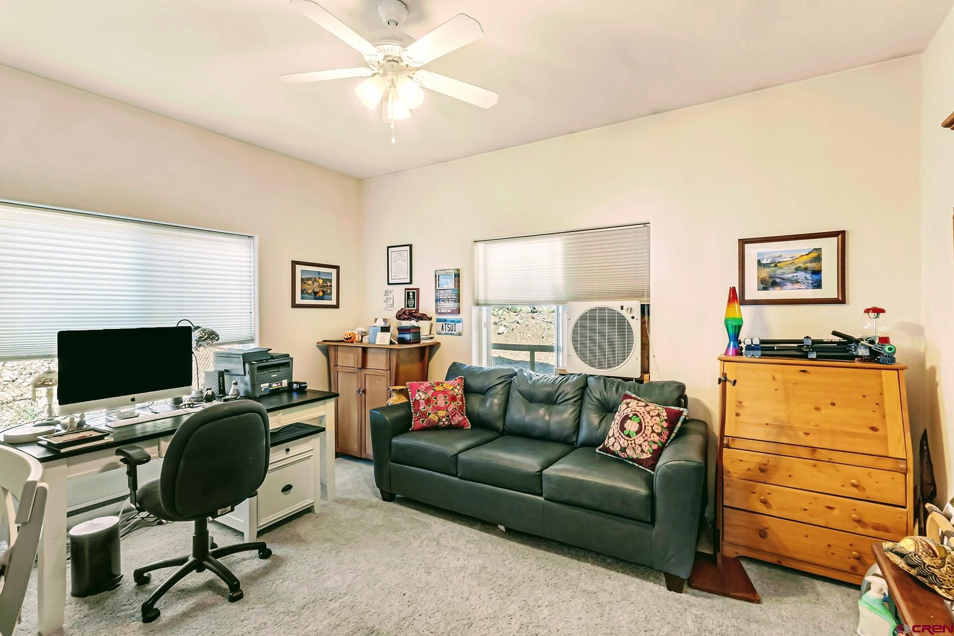 20613 High Park Road Cedaredge, CO 81413 - Photo 23 of 35 a living room with furniture and a flat screen tv