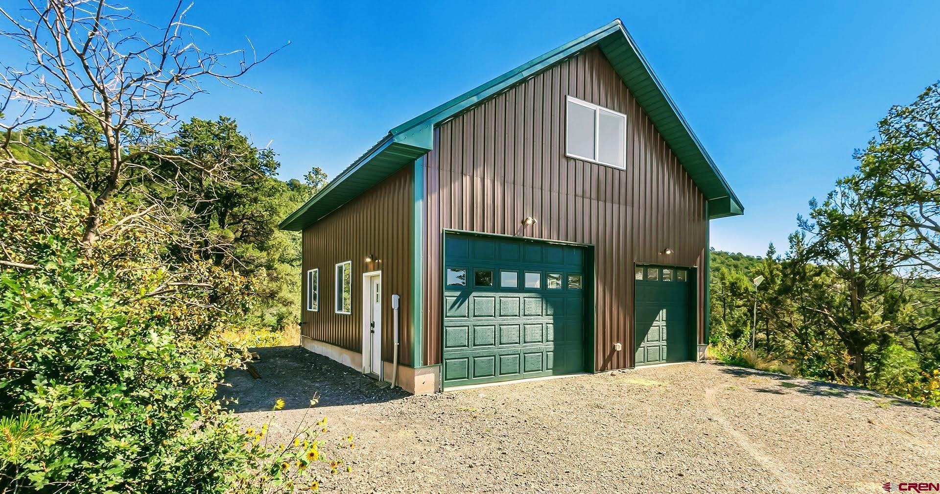 20613 High Park Road Cedaredge, CO 81413 - Photo 31 of 35 a front view of a house with a yard and garage