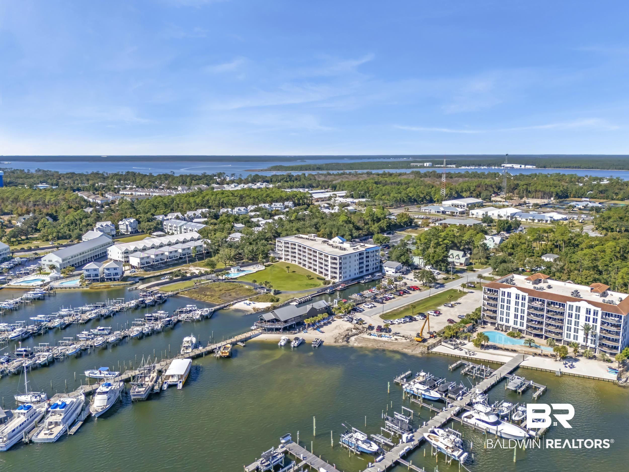 27282 Canal Road, Unit 104 Orange Beach, AL 36561 - Photo 3 of 79 Drone / aerial view of numerous boat docks and a nearby body of water