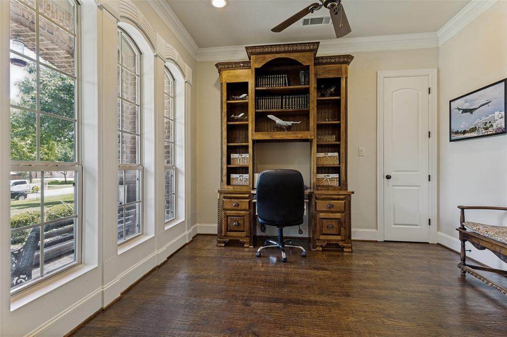 229 Arbor Lane Haslet, TX 76052 - Photo 6 of 34 Hardwood flooring throughout featuring a built-in wooden desk and shelving unit, crown molding, and a ceiling fan