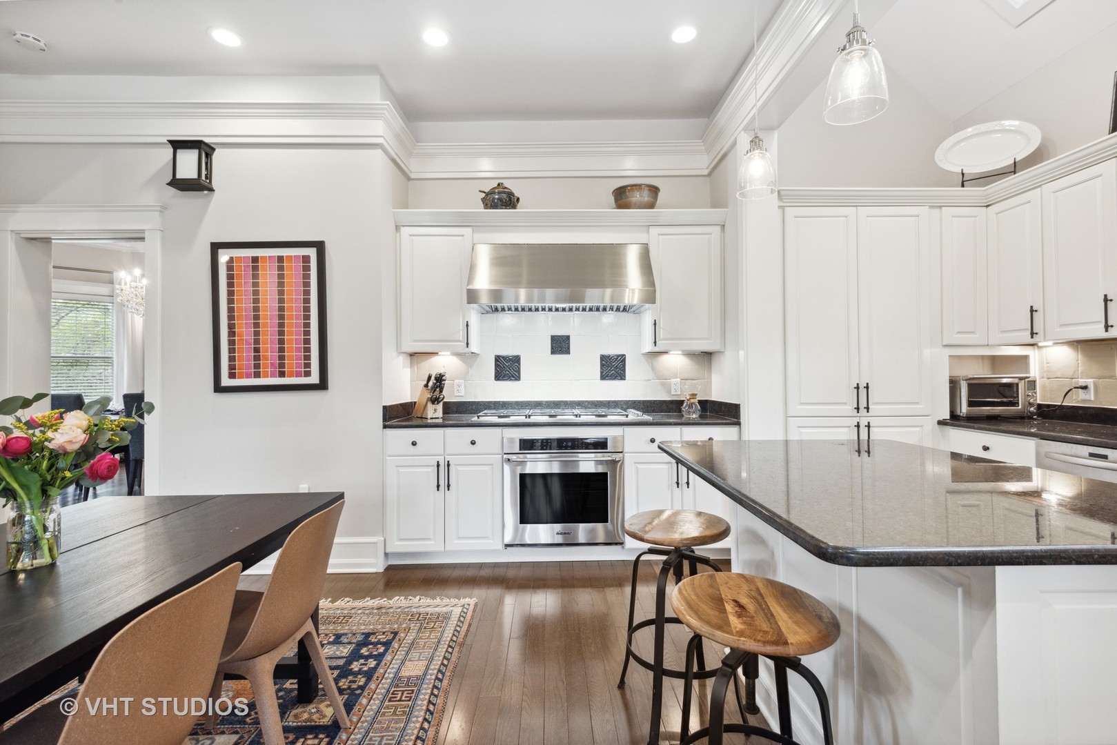 1224 Maple Avenue Evanston, IL 60202 - Photo 26 of 71 a kitchen with stainless steel appliances granite countertop a stove top oven a sink a dining table and chairs with wooden floor