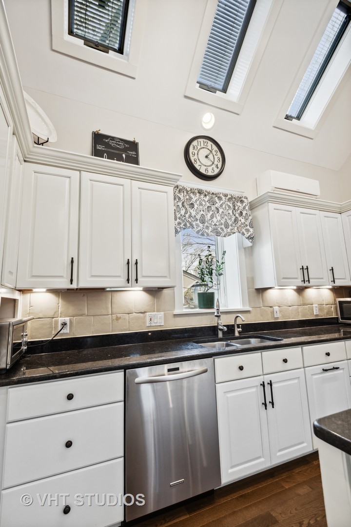 1224 Maple Avenue Evanston, IL 60202 - Photo 30 of 71 a kitchen with granite countertop white cabinets and white appliances