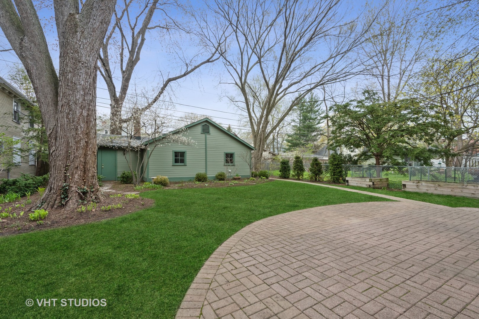 1224 Maple Avenue Evanston, IL 60202 - Photo 66 of 71 a view of a backyard with table and chairs and a large tree
