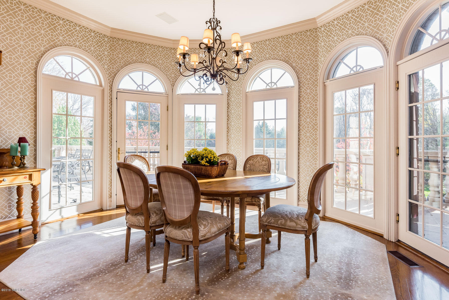 56 North Stanwich Road Greenwich, CT 06831 - Photo 9 of 30 a view of a dining room with furniture a chandelier and wooden floor