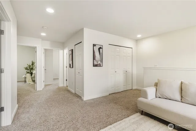 a living room with furniture and a ceiling fan